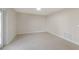 An airy room with natural light, neutral walls, tile floors, baseboards, and an entry door at 99 Eastridge Dr, Eustis, FL 32726