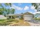Charming single-story home with a well-manicured lawn, attached garage and neutral paint at 99 Eastridge Dr, Eustis, FL 32726