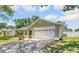 Charming single-story home with a well-manicured lawn, attached garage and neutral paint at 99 Eastridge Dr, Eustis, FL 32726