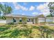 Charming single-story home with a well-manicured lawn, attached garage and neutral paint at 99 Eastridge Dr, Eustis, FL 32726