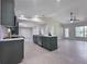 Bright, open kitchen and living area with an island and new appliances at 99 Eastridge Dr, Eustis, FL 32726