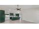 Modern kitchen featuring dark green cabinetry, a center island, stainless appliances, and lots of natural light at 99 Eastridge Dr, Eustis, FL 32726