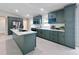 Wide angle of kitchen showcasing green cabinets, stainless appliances, quartz countertops and kitchen island at 99 Eastridge Dr, Eustis, FL 32726