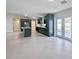 Open-concept kitchen boasts stylish green cabinetry, stainless steel appliances, and a large island at 99 Eastridge Dr, Eustis, FL 32726