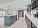 Contemporary kitchen with shaker cabinets, stainless appliances, quartz counters and island sink at 99 Eastridge Dr, Eustis, FL 32726