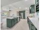 Modern kitchen featuring dark green cabinetry, a center island, stainless appliances, and lots of natural light at 99 Eastridge Dr, Eustis, FL 32726