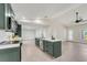Modern kitchen with stainless steel appliances, center island with sink, and white countertops at 99 Eastridge Dr, Eustis, FL 32726