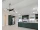 Modern kitchen featuring dark green cabinetry, a center island, stainless appliances, and lots of natural light at 99 Eastridge Dr, Eustis, FL 32726