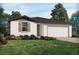 Charming single-story home featuring a well-manicured lawn and a two-car garage, creating a welcoming curb appeal at 1106 Cumberland Trail Dr, Lake Hamilton, FL 33851