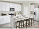 Bright, modern kitchen with white cabinets, stainless steel appliances, and a breakfast bar at 1110 Cumberland Trail Dr, Lake Hamilton, FL 33851