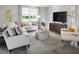 Cozy living room featuring a comfortable sofa, modern decor, and abundant natural light at 1110 Cumberland Trail Dr, Lake Hamilton, FL 33851