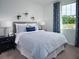 Calming bedroom with a comfortable bed, side tables, and a sunny window view at 1122 Cumberland Trail Dr, Lake Hamilton, FL 33851