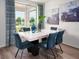 Bright dining room features stylish décor, a large window view, and a modern marble table at 1122 Cumberland Trail Dr, Lake Hamilton, FL 33851