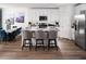 Modern kitchen features white cabinets, stainless steel appliances, and a stylish island with barstool seating at 1122 Cumberland Trail Dr, Lake Hamilton, FL 33851