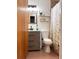 Bathroom featuring modern vanity, neutral tiling, updated fixtures and decorative mirror and shelving at 1150 Jackson St, Oviedo, FL 32765