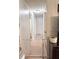 Hallway with access to rooms and tiled floors, featuring a neutral color palette and built in safety gate at 1150 Jackson St, Oviedo, FL 32765