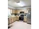 Functional kitchen with stainless steel appliances, wood-style cabinets and ample counter space at 1150 Jackson St, Oviedo, FL 32765