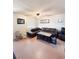 Cozy living room features a large leather sectional, neutral walls, and comfortable seating arrangement at 1150 Jackson St, Oviedo, FL 32765