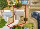 Aerial view of a home showcasing the property, driveway, and proximity to the pond at 117 Clowson Ct, Ocoee, FL 34761
