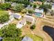 Aerial view captures a cozy home near a picturesque pond, amidst lush trees at 117 Clowson Ct, Ocoee, FL 34761