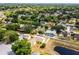 Scenic aerial shot of a neighborhood nestled amidst trees, featuring homes with backyard pools at 117 Clowson Ct, Ocoee, FL 34761