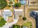 Aerial view of a home showcasing the property, driveway, and proximity to the pond at 117 Clowson Ct, Ocoee, FL 34761