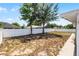 Back yard with grass and a white fence at 117 Clowson Ct, Ocoee, FL 34761