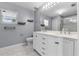 Bathroom with double vanity, marble floors, bright lights, and a glass shower at 117 Clowson Ct, Ocoee, FL 34761