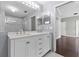 Well-lit bathroom with double vanity and glass-enclosed shower at 117 Clowson Ct, Ocoee, FL 34761