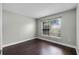 Bedroom with wood flooring and a window with a view of the backyard at 117 Clowson Ct, Ocoee, FL 34761