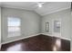 Neutral bedroom with hardwood floors, ceiling fan and view of the backyard at 117 Clowson Ct, Ocoee, FL 34761