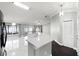 Open concept kitchen featuring modern white cabinets, stainless steel appliances, and marble flooring at 117 Clowson Ct, Ocoee, FL 34761