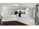 Open concept design connects the kitchen and living area with an eat-in bar, marble and hardwood flooring at 117 Clowson Ct, Ocoee, FL 34761