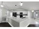 Bright kitchen with white cabinets, island, stainless appliances, and stone countertops at 117 Clowson Ct, Ocoee, FL 34761
