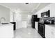 Bright kitchen boasts white cabinets, stainless steel appliances, and modern backsplash at 117 Clowson Ct, Ocoee, FL 34761