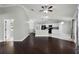 Open living room and kitchen area with hardwood floors and vaulted ceilings at 117 Clowson Ct, Ocoee, FL 34761