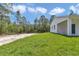 Landscaped backyard is a perfect setting for outdoor enjoyment with mature trees in the background at 12197 Sw 76 Ln, Dunnellon, FL 34432