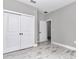This bedroom offers a closet and features light-colored wood-look tile at 12197 Sw 76 Ln, Dunnellon, FL 34432