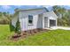 Charming single-story home features modern white siding, manicured landscaping, and a convenient attached garage at 12197 Sw 76 Ln, Dunnellon, FL 34432