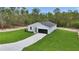 An inviting house shows off a verdant lawn, concrete driveway, and minimalist landscaping at 12197 Sw 76 Ln, Dunnellon, FL 34432