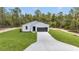 A bright home showcases a well-manicured lawn, a sleek garage door, and fresh landscaping at 12197 Sw 76 Ln, Dunnellon, FL 34432