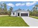 Well-maintained single-story home featuring a modern design, fresh landscaping, and an attached garage at 12197 Sw 76 Ln, Dunnellon, FL 34432