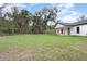 Spacious backyard featuring a newly built home with modern design and a large grassy lawn at 12460 Sw 48 Lane Rd, Ocala, FL 34481