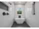 Bright bathroom featuring a modern tub under a window and subway tile at 12460 Sw 48 Lane Rd, Ocala, FL 34481