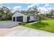 Modern farmhouse exterior with attached garage, concrete driveway, and manicured lawn at 12460 Sw 48 Lane Rd, Ocala, FL 34481