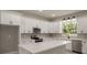 Bright kitchen features white cabinetry, stainless steel appliances and quartz countertops at 12460 Sw 48 Lane Rd, Ocala, FL 34481
