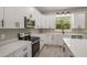 Well-appointed kitchen featuring stainless appliances, quartz countertops and a center island at 12460 Sw 48 Lane Rd, Ocala, FL 34481