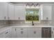 Bright kitchen with stainless appliances, quartz countertops and a window view to the backyard at 12460 Sw 48 Lane Rd, Ocala, FL 34481