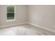 Neutral room with wood-look tile and backyard view at 12460 Sw 48 Lane Rd, Ocala, FL 34481
