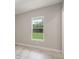Neutral room with wood-look tile and view of backyard at 12460 Sw 48 Lane Rd, Ocala, FL 34481
